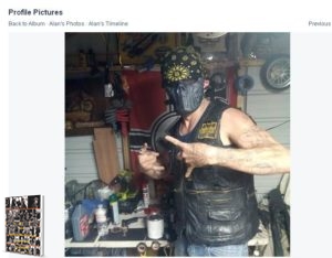 Facebook image of an Upsher County Cossack with a riding mask in his garage, where there happens to be a Nazi war flag hanging behind him. Circa 2014.